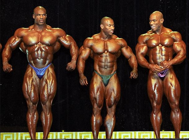 Ronnie, Dexter and Flex on stage posing